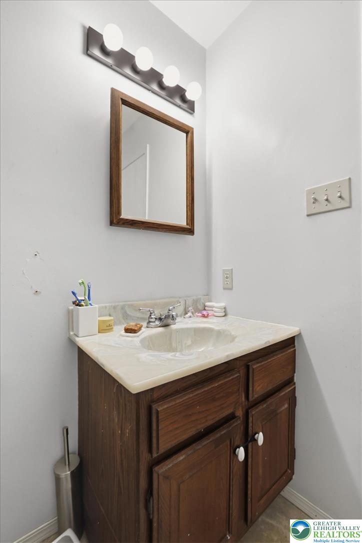 520 Highland Hill Road Jim Thorpe, PA 18235 - Photo 37 of 83 A well-maintained vanity features a spacious basin and storage, illuminated by overhead lighting, offering practical elegance.