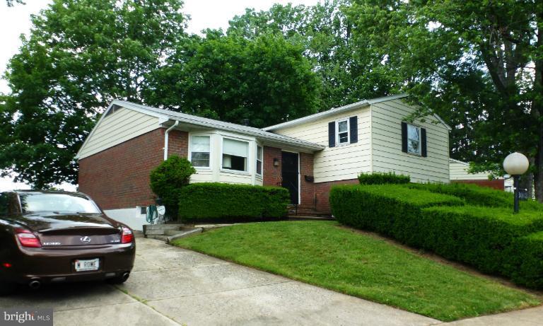 3003 Northbrook Road Baltimore, MD 21208 - Photo 1 of 19 a front view of a house with a garden and yard