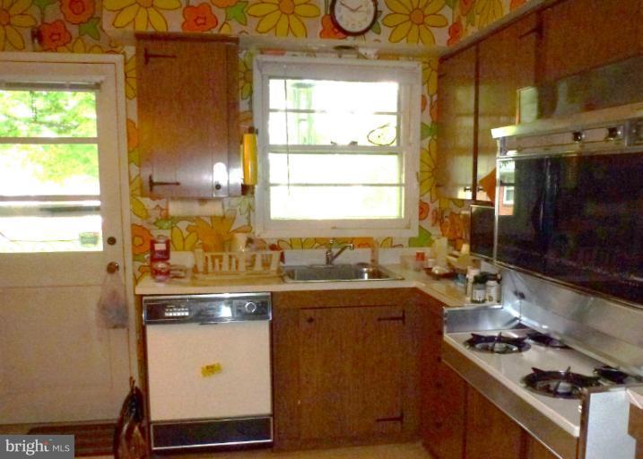 3003 Northbrook Road Baltimore, MD 21208 - Photo 5 of 19 a kitchen with a sink a stove cabinets and a window