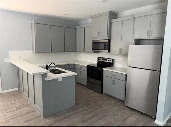 a kitchen with cabinets a sink and white stainless steel appliances