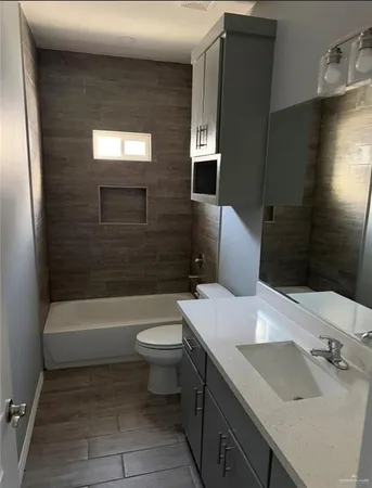 a bathroom with a sink a toilet and bathtub