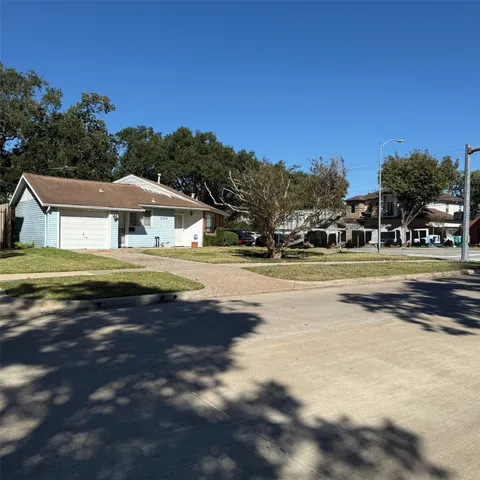 a view of house with outdoor space and swimming pool