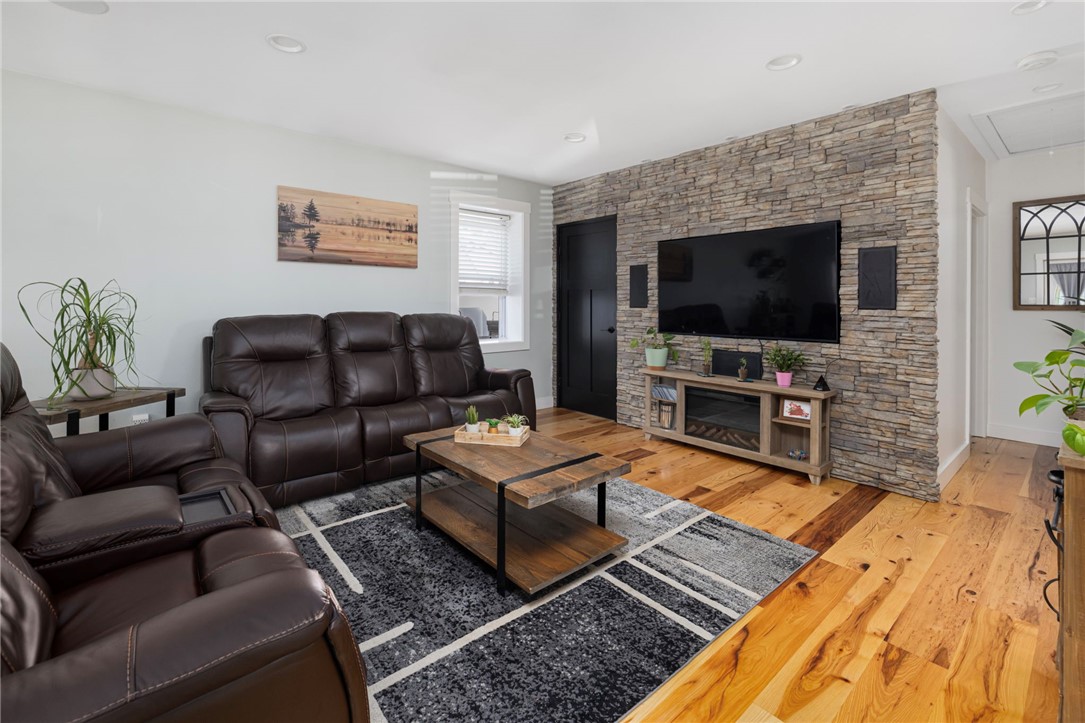 145 Jenckes Hill Road Lincoln, RI 02865 - Photo 14 of 39 Gorgeous hardwood floors continue into the open living room. This room boasts high ceilings, a stone accent wall, recessed lighting and access to the side patio.