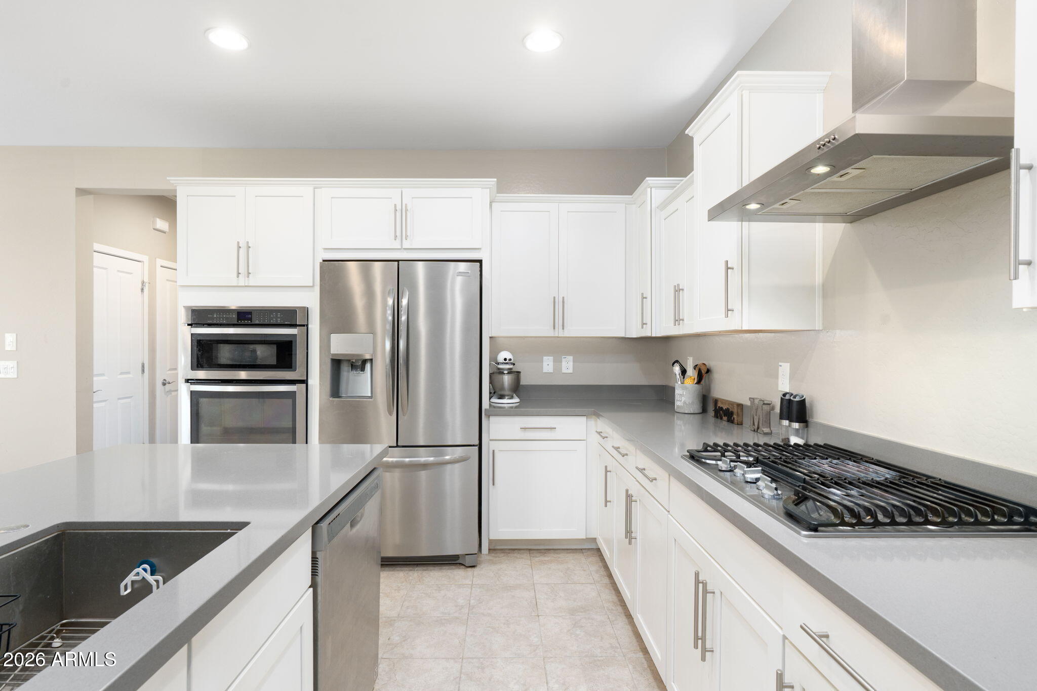 4041 East Amber Lane Gilbert, AZ 85296 - Photo 11 of 31 a kitchen with a refrigerator and a sink
