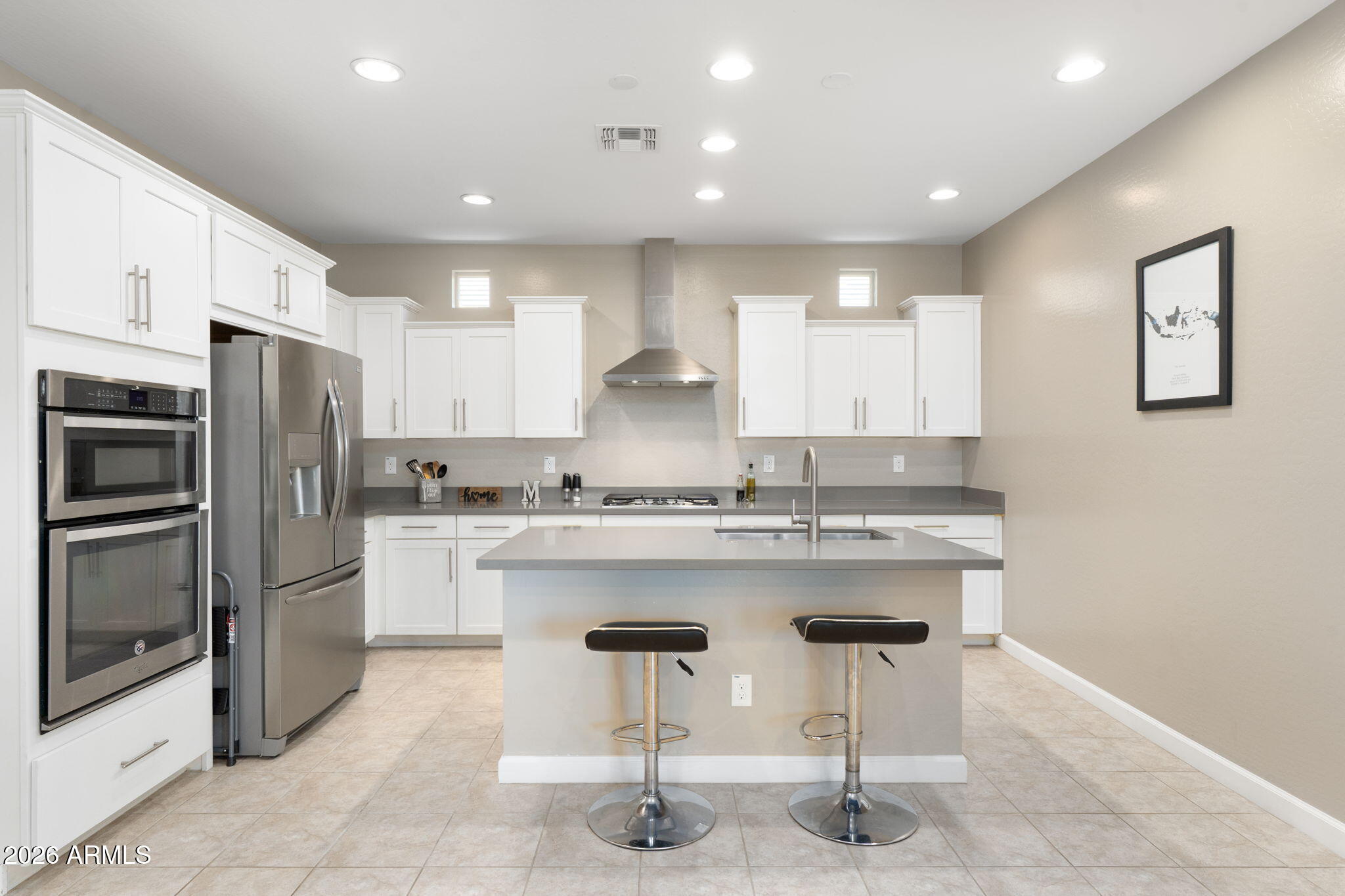 4041 East Amber Lane Gilbert, AZ 85296 - Photo 14 of 31 a kitchen with kitchen island granite countertop wooden cabinets and refrigerator