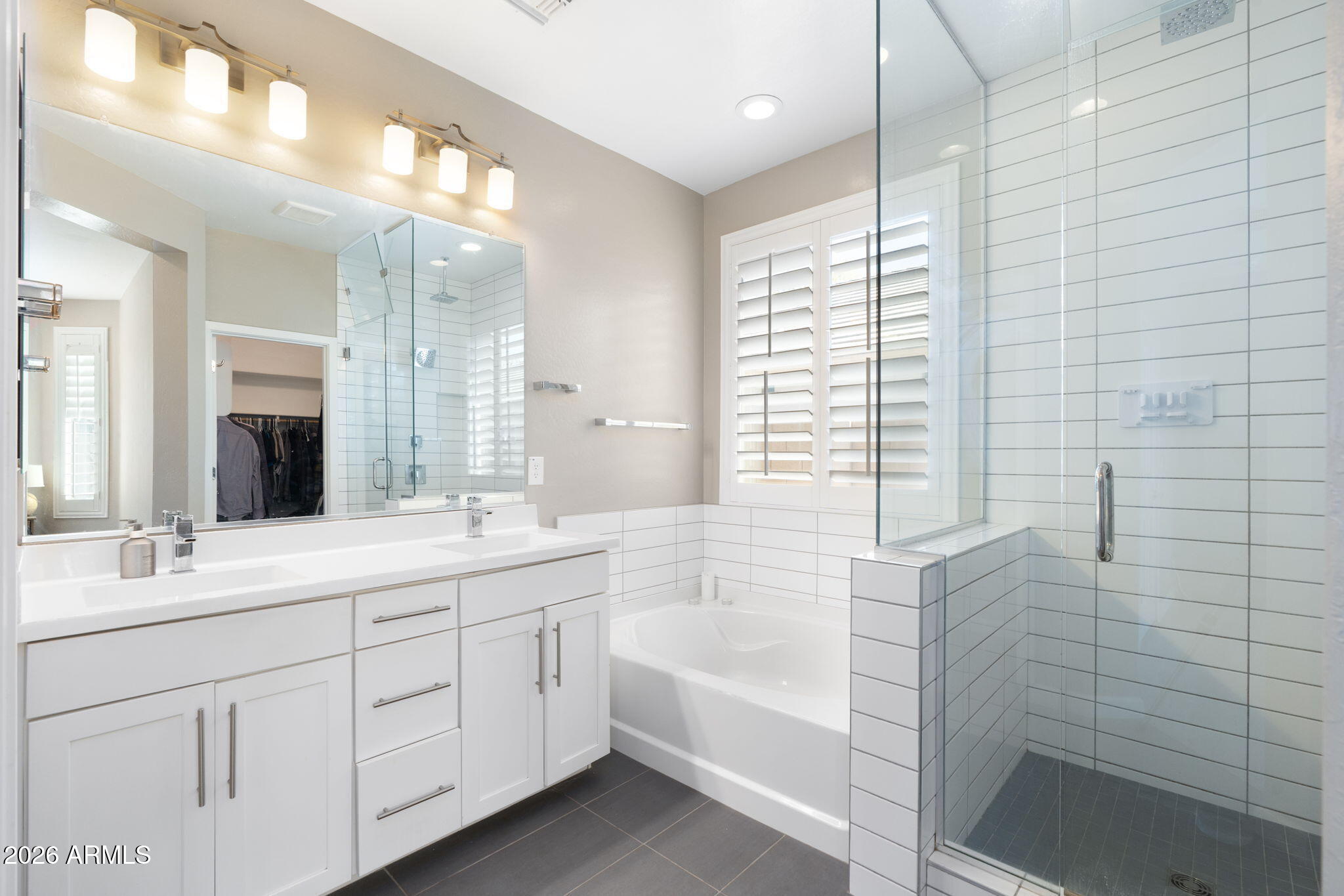 4041 East Amber Lane Gilbert, AZ 85296 - Photo 18 of 31 a bathroom with a double vanity sink a large mirror and shower