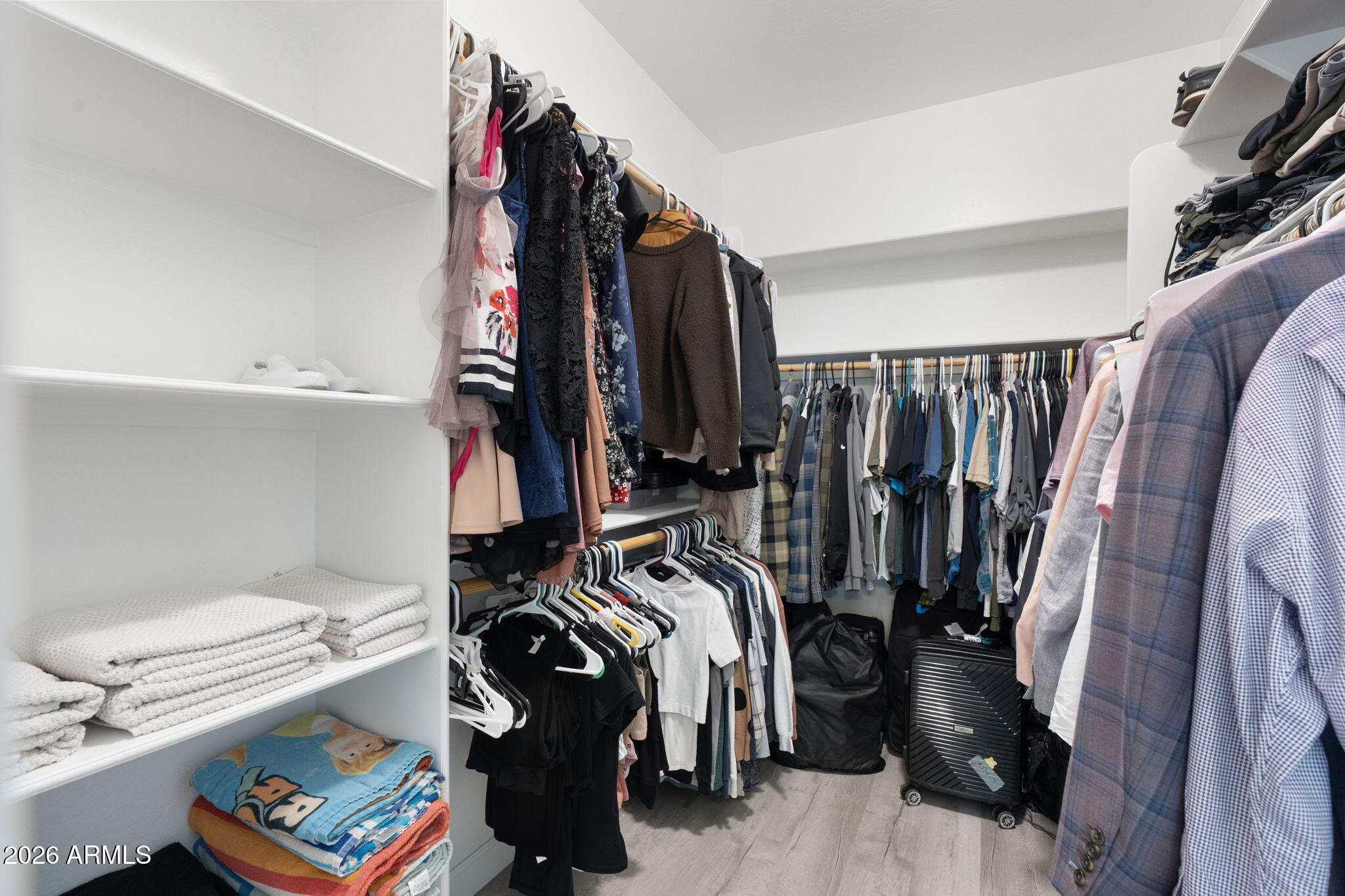4041 East Amber Lane Gilbert, AZ 85296 - Photo 19 of 31 a view of walk in closet with clothes and shoes