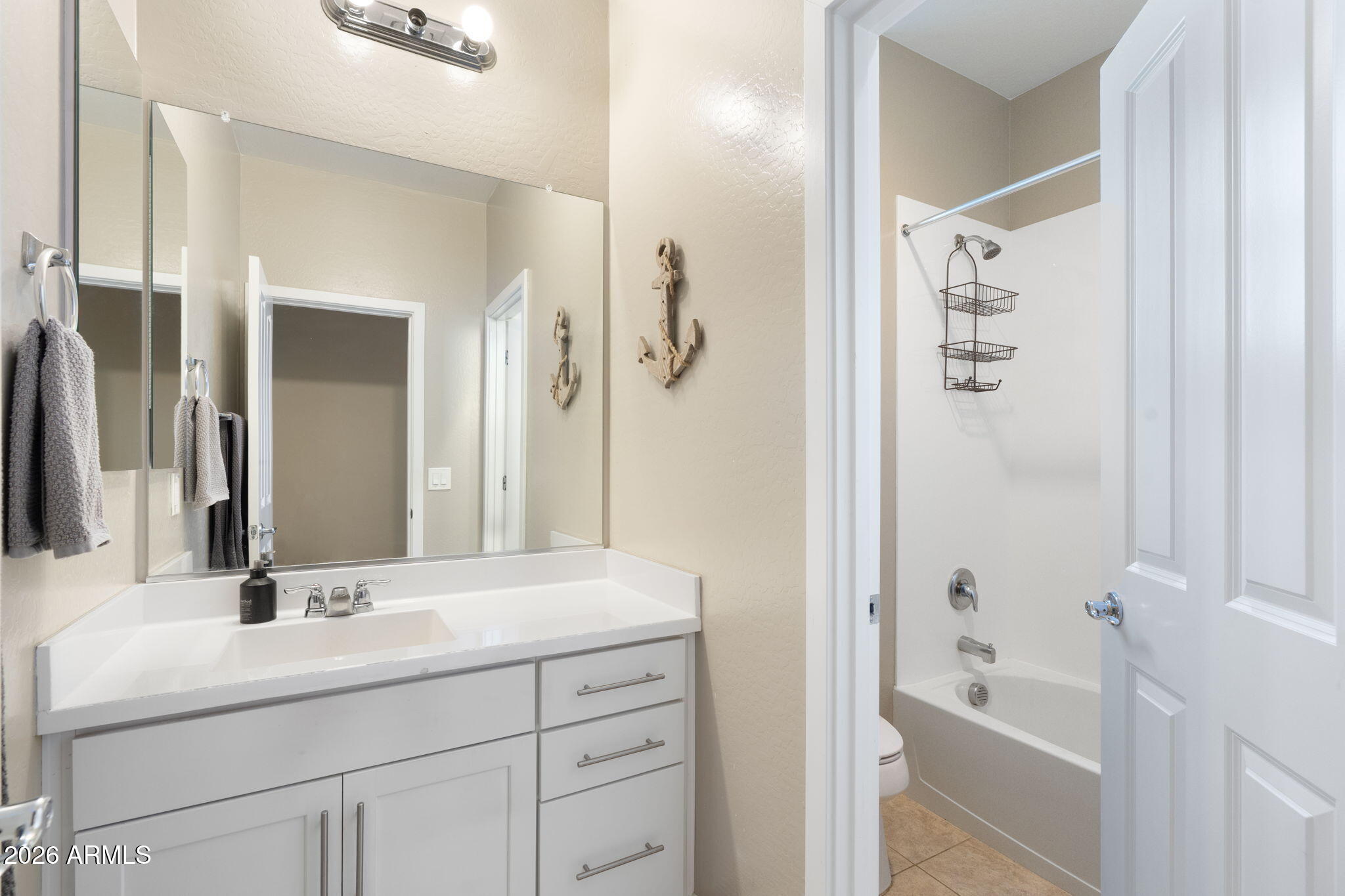 4041 East Amber Lane Gilbert, AZ 85296 - Photo 5 of 31 a bathroom with a tub sink and mirror