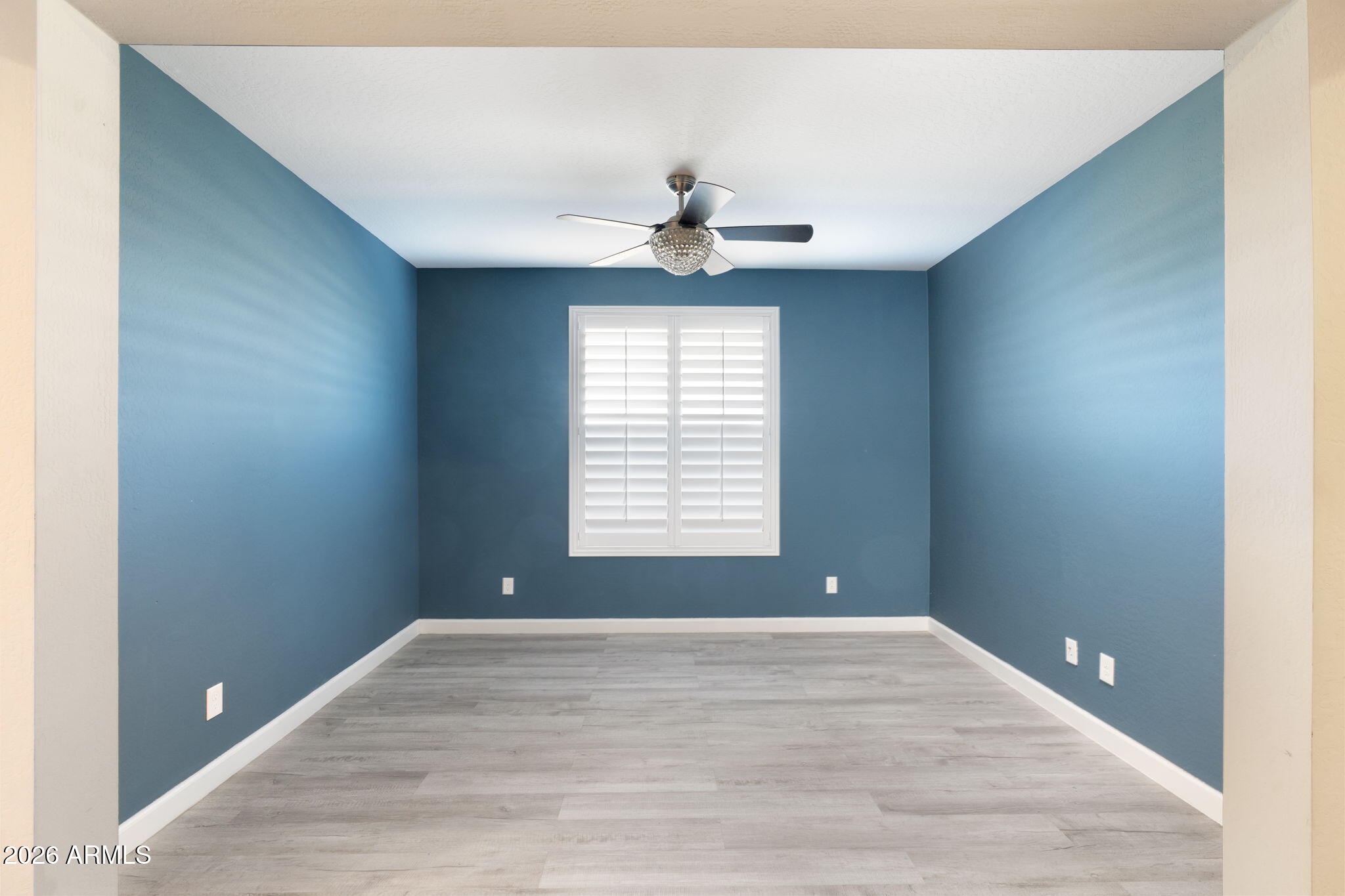 4041 East Amber Lane Gilbert, AZ 85296 - Photo 6 of 31 a view of empty room with window and a ceiling fan