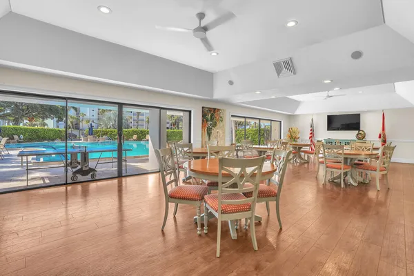 a dining room with furniture window and wooden floor