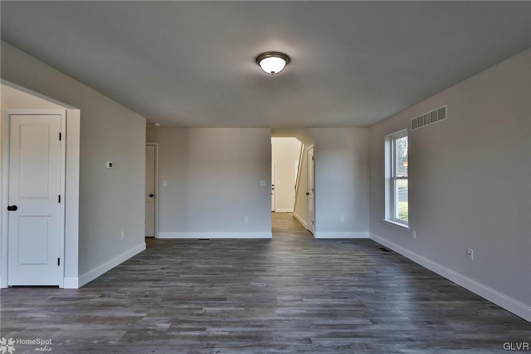647 Sipos Drive Northampton, PA 18067 - Photo 15 of 47 a view of an empty room with window and wooden floor