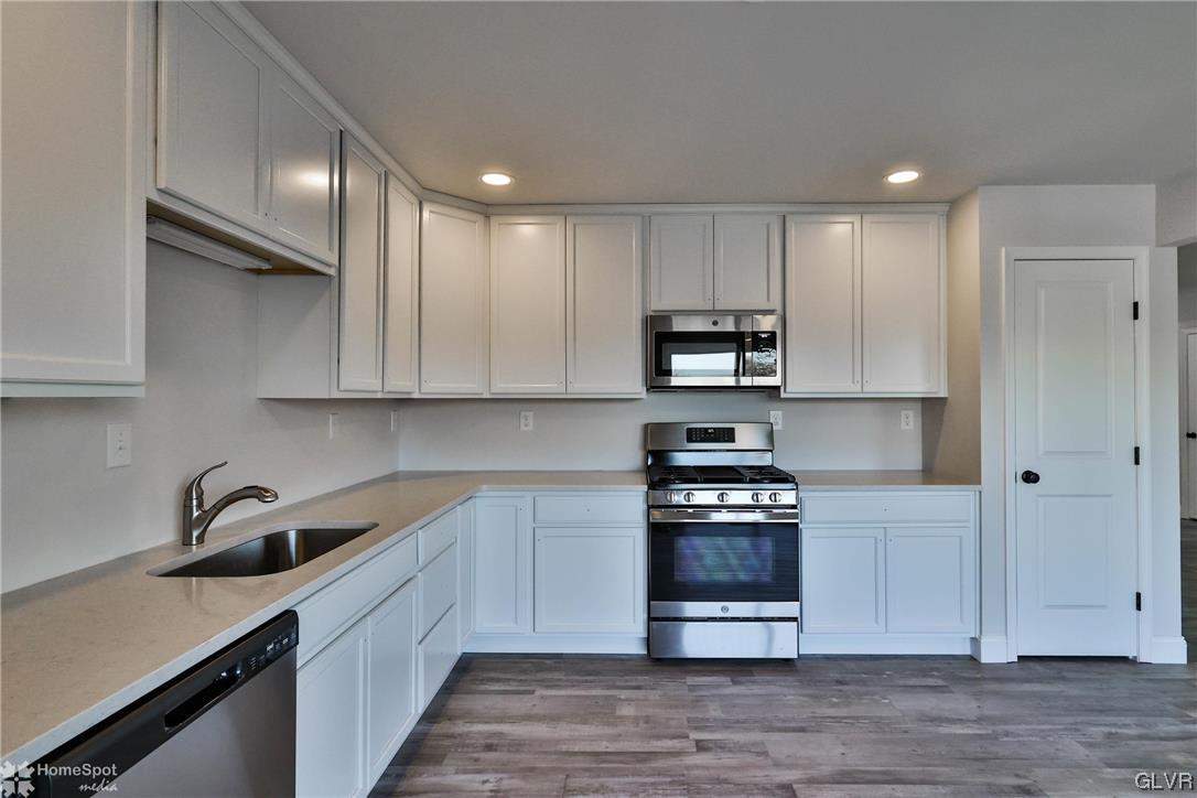 647 Sipos Drive Northampton, PA 18067 - Photo 18 of 47 a kitchen with granite countertop a refrigerator and a sink