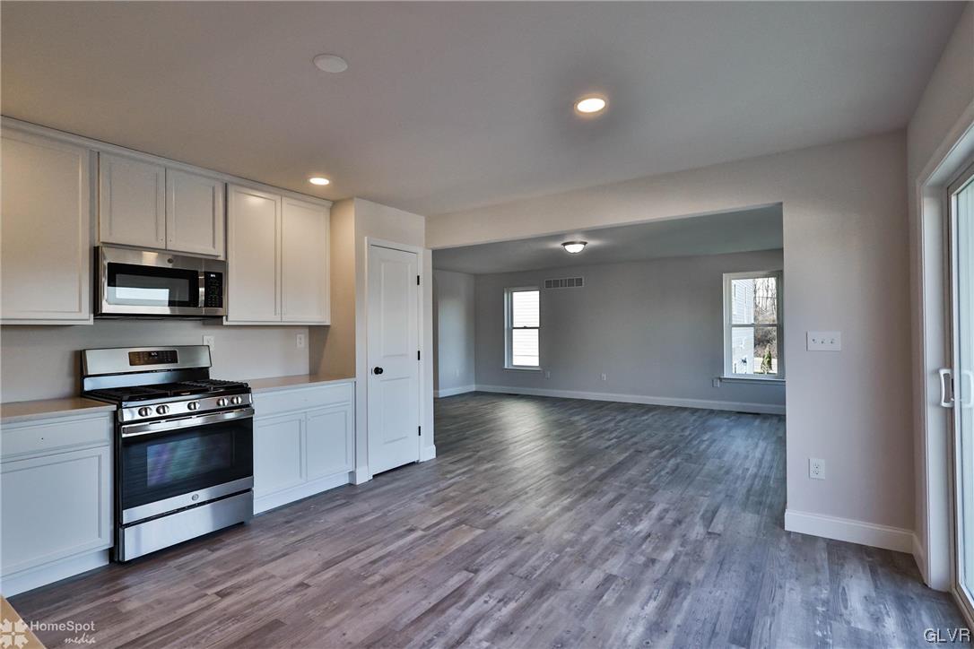 647 Sipos Drive Northampton, PA 18067 - Photo 19 of 47 a view of a kitchen with microwave and wooden floor