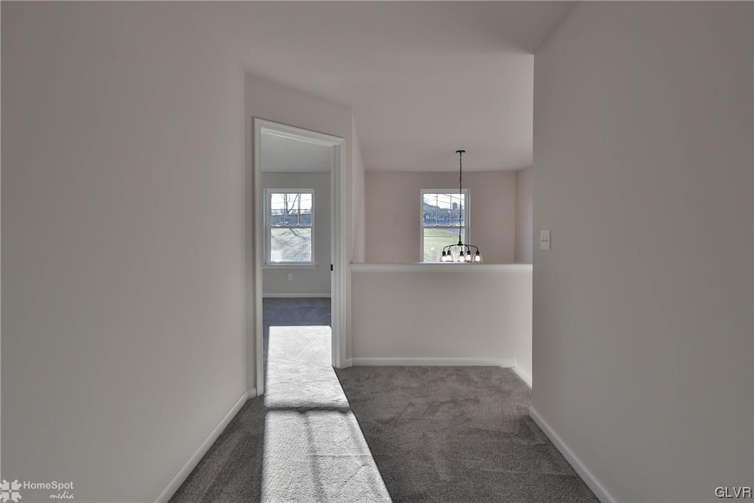 647 Sipos Drive Northampton, PA 18067 - Photo 29 of 47 a view of a hallway with wooden floor and a bathroom