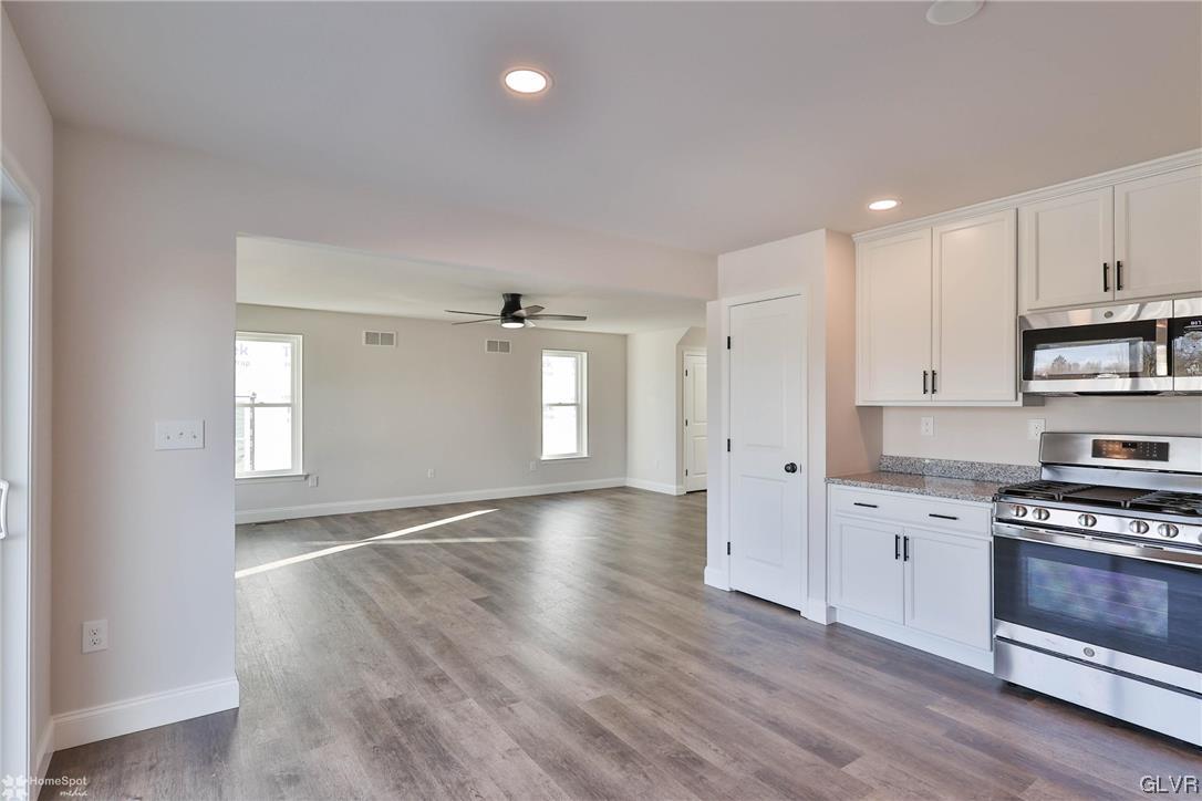 647 Sipos Drive Northampton, PA 18067 - Photo 8 of 47 a view of kitchen with granite countertop cabinets and wooden floor