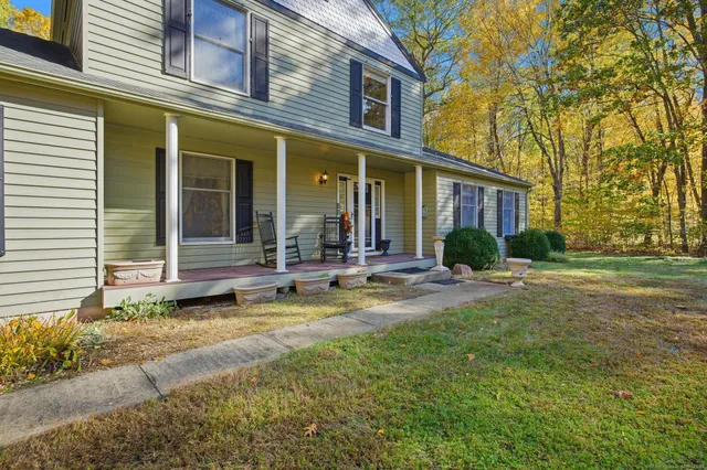 a view of a house with backyard and sitting area