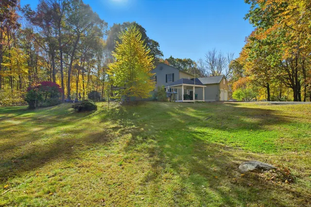 a view of a field of grass and trees