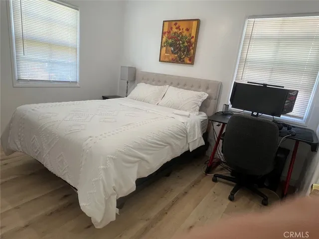 a bed sitting in a bedroom next to a window