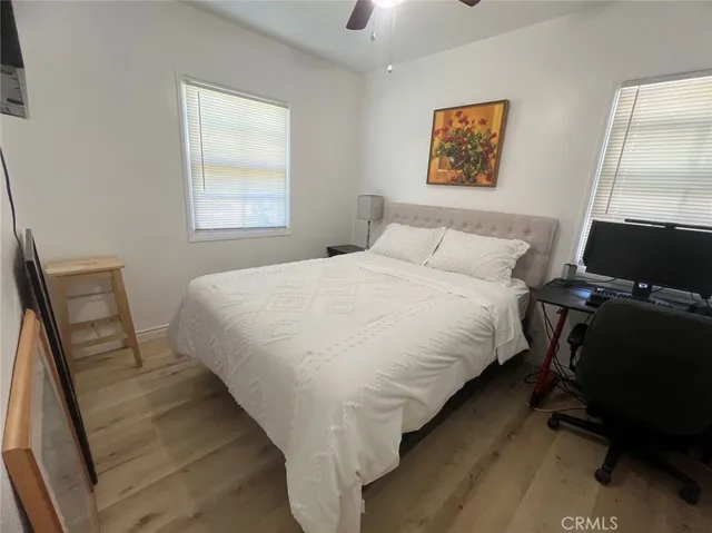 a bedroom with bed and a window