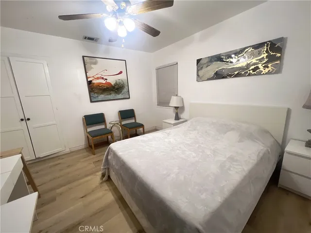 a bedroom with bed and a chandelier