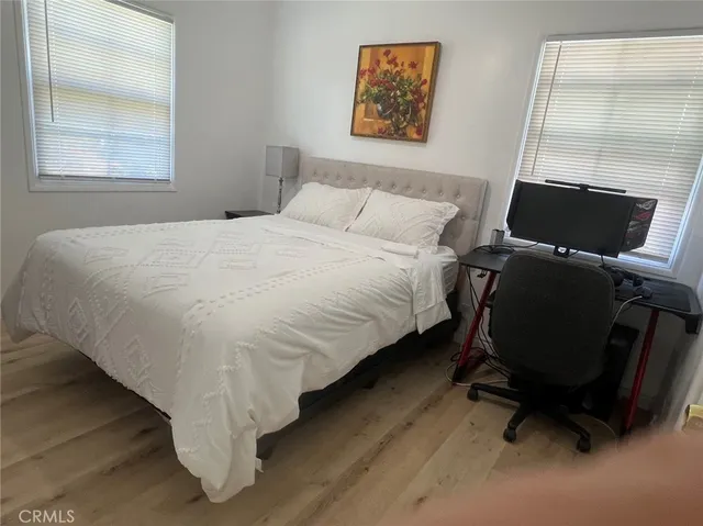 a bed sitting in a bedroom next to a window