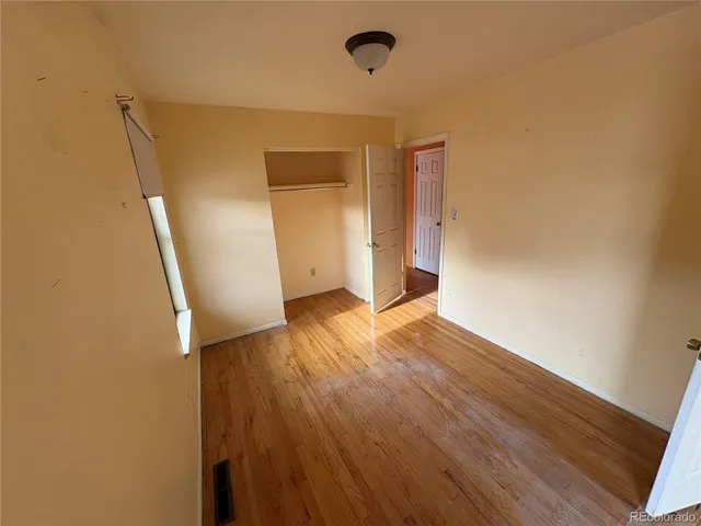 a view of hallway with wooden floor