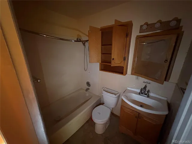 a bathroom with a toilet and a mirror