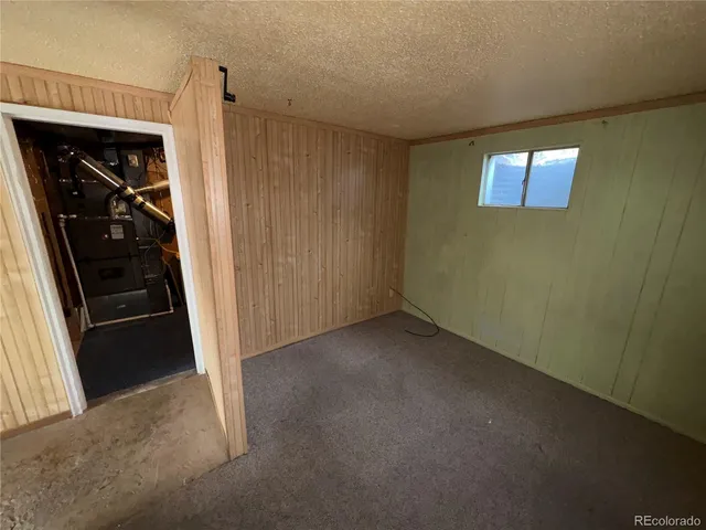 a view of a hallway to a room with a window