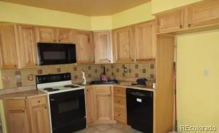 a kitchen with stainless steel appliances a stove a microwave and a sink