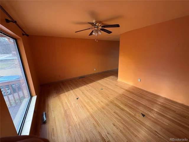 a view of a big room with wooden floor and staircase