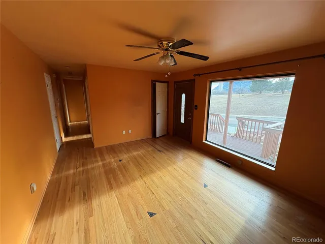 a view of an empty room and wooden floor