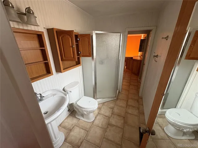 a bathroom with a toilet and a shower