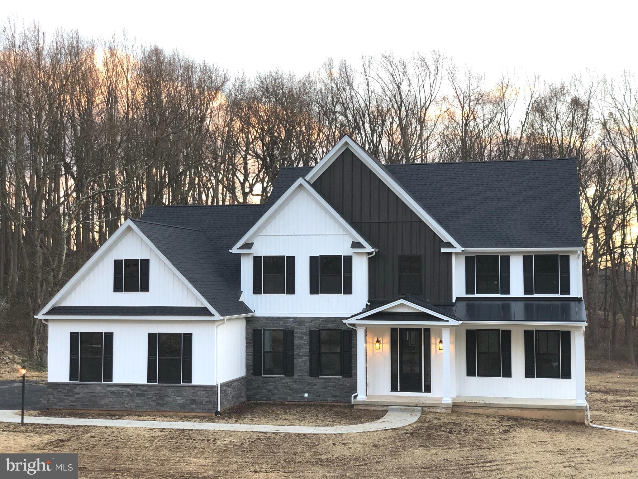 689 Cheyney Road Glen Mills, PA 19319 - Photo 2 of 11 a front view of a house with a yard and garage