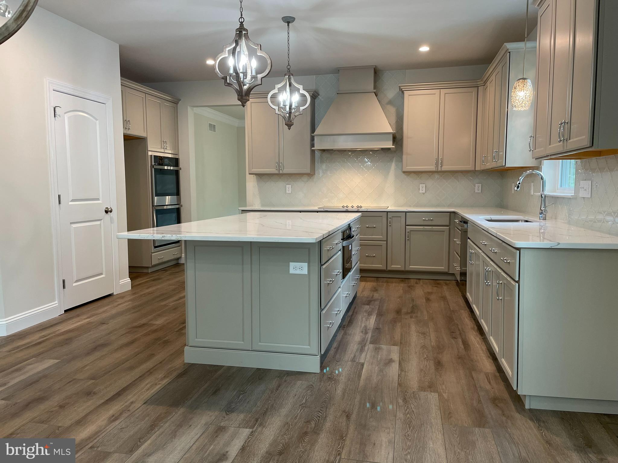 689 Cheyney Road Glen Mills, PA 19319 - Photo 4 of 11 a kitchen with stainless steel appliances granite countertop wooden floors and stove
