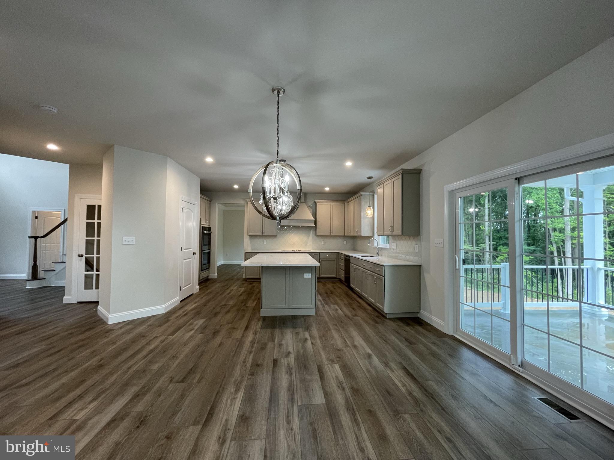 689 Cheyney Road Glen Mills, PA 19319 - Photo 5 of 11 an open kitchen with wooden floor and stainless steel appliances