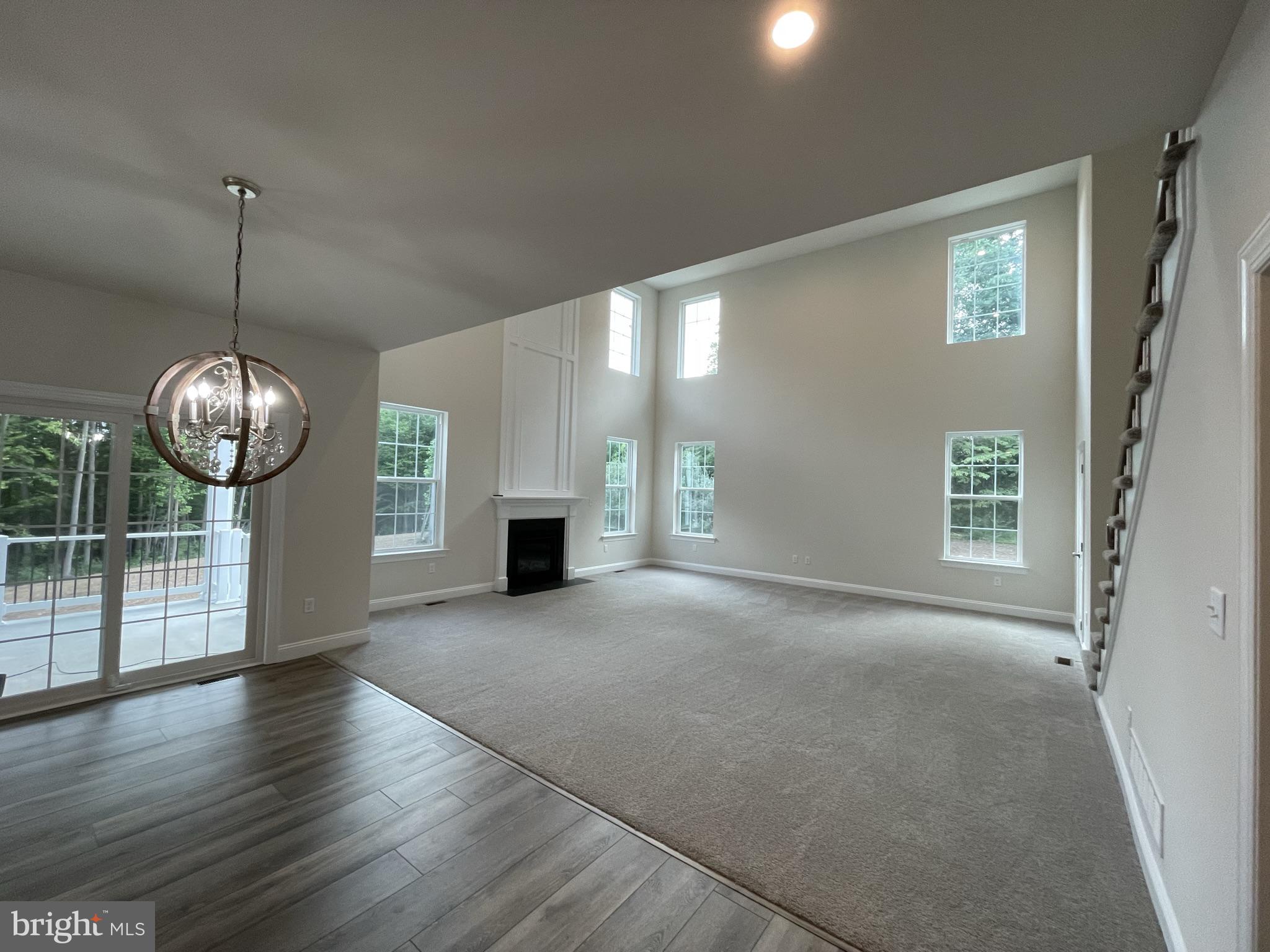 689 Cheyney Road Glen Mills, PA 19319 - Photo 6 of 11 a view of empty room with wooden floor and fireplace