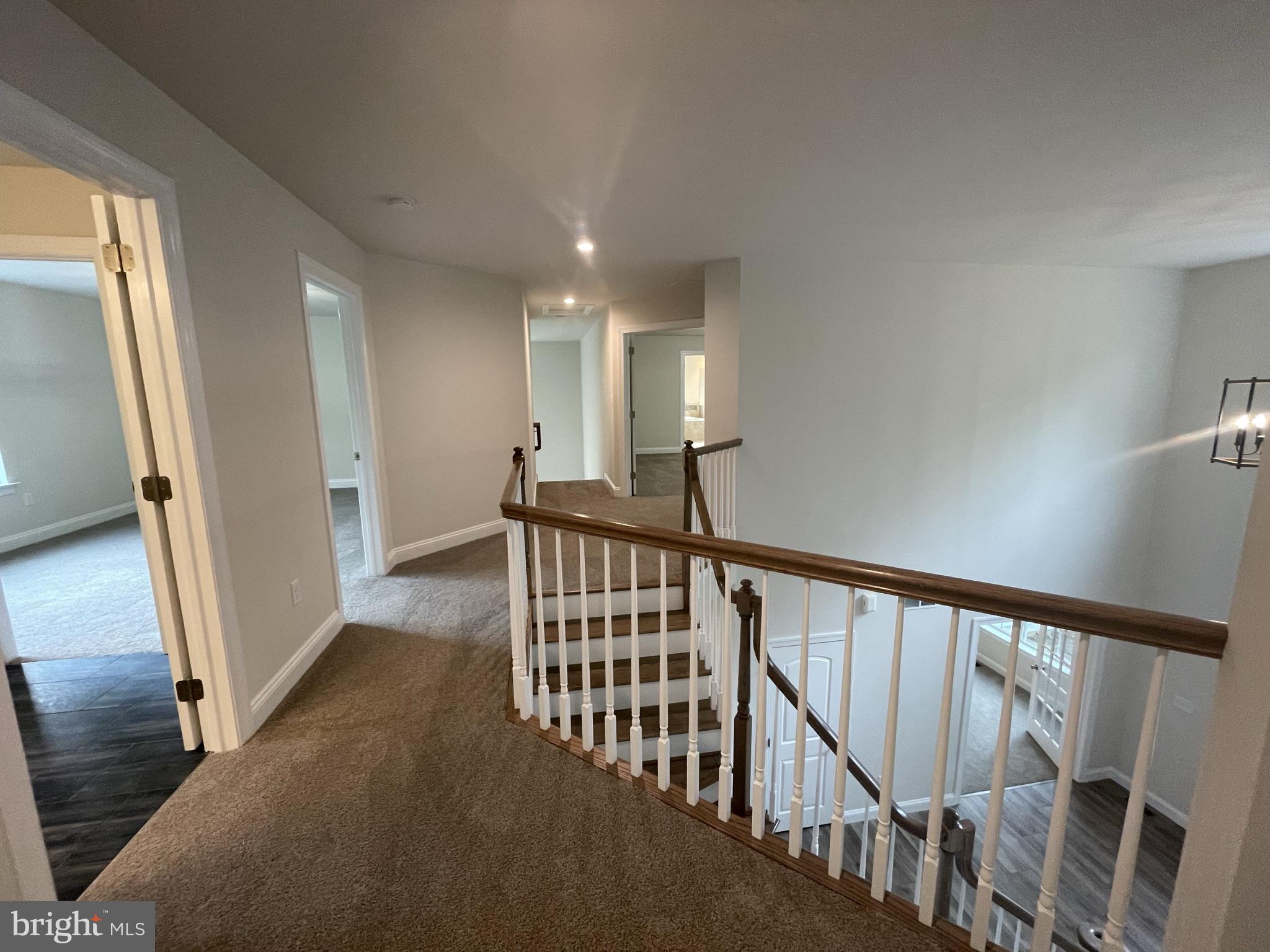 689 Cheyney Road Glen Mills, PA 19319 - Photo 7 of 11 a view of staircase with lots of frames on wall and wooden floor