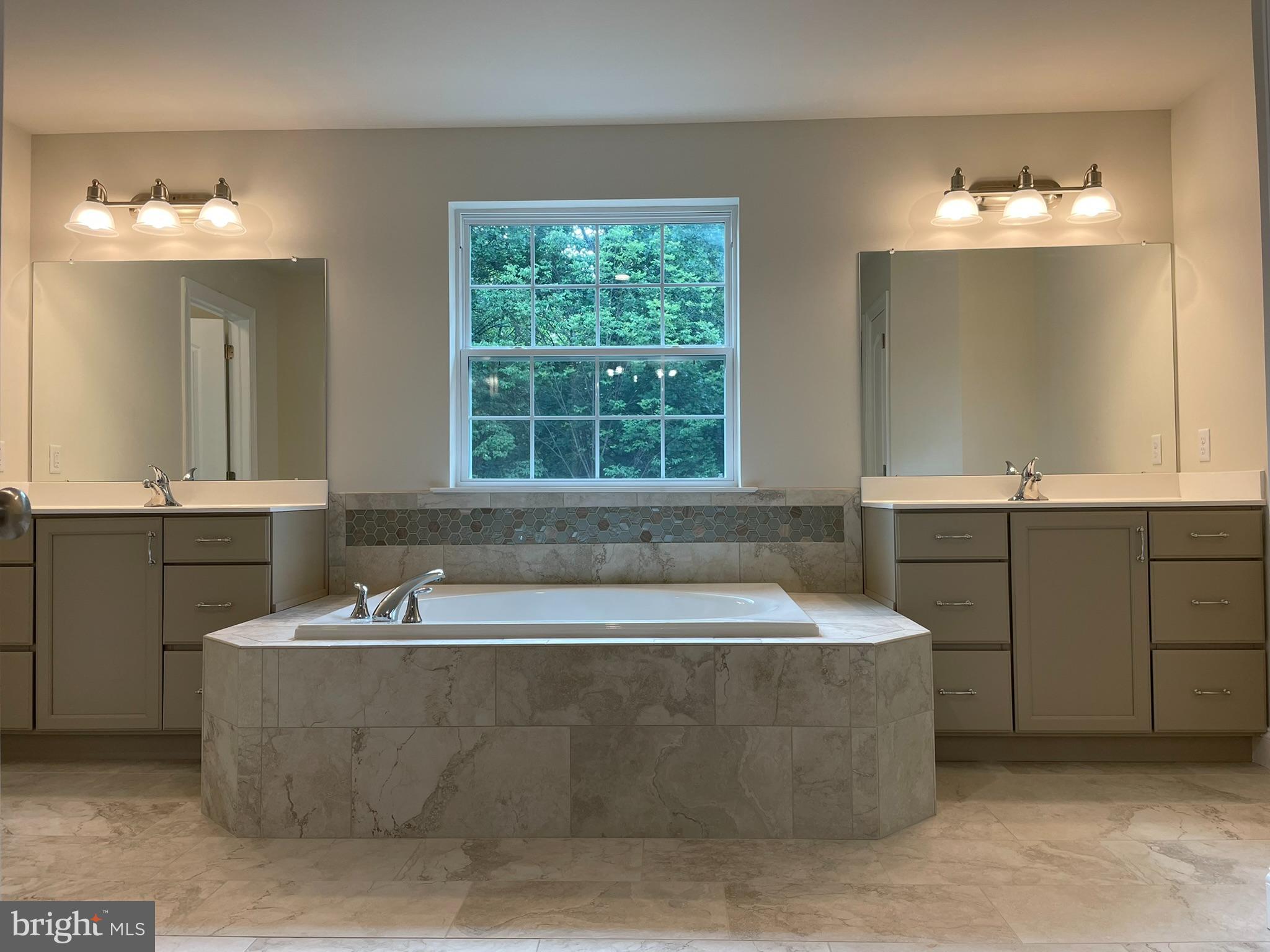 689 Cheyney Road Glen Mills, PA 19319 - Photo 8 of 11 a bath tub sitting in a bathroom next to a bathroom sink