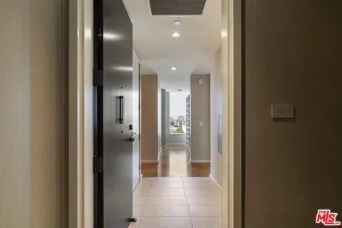 a view of a hallway with wooden shelves