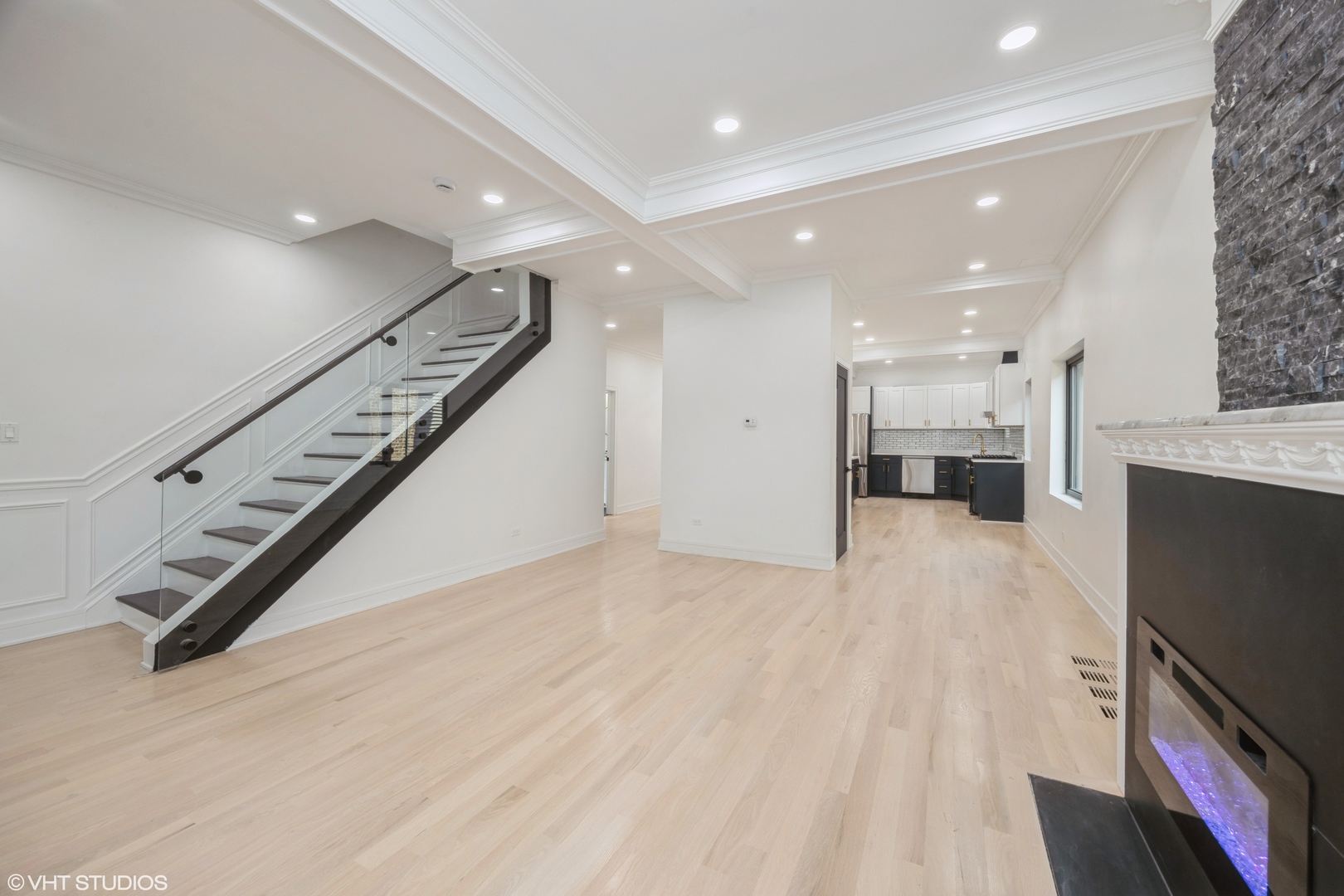 2230 South Ridgeway Avenue Chicago, IL 60623 - Photo 2 of 13 a view of an empty room with wooden floor and a kitchen