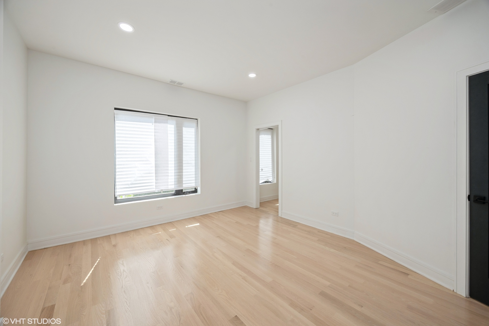 2230 South Ridgeway Avenue Chicago, IL 60623 - Photo 8 of 13 an empty room with wooden floor and windows