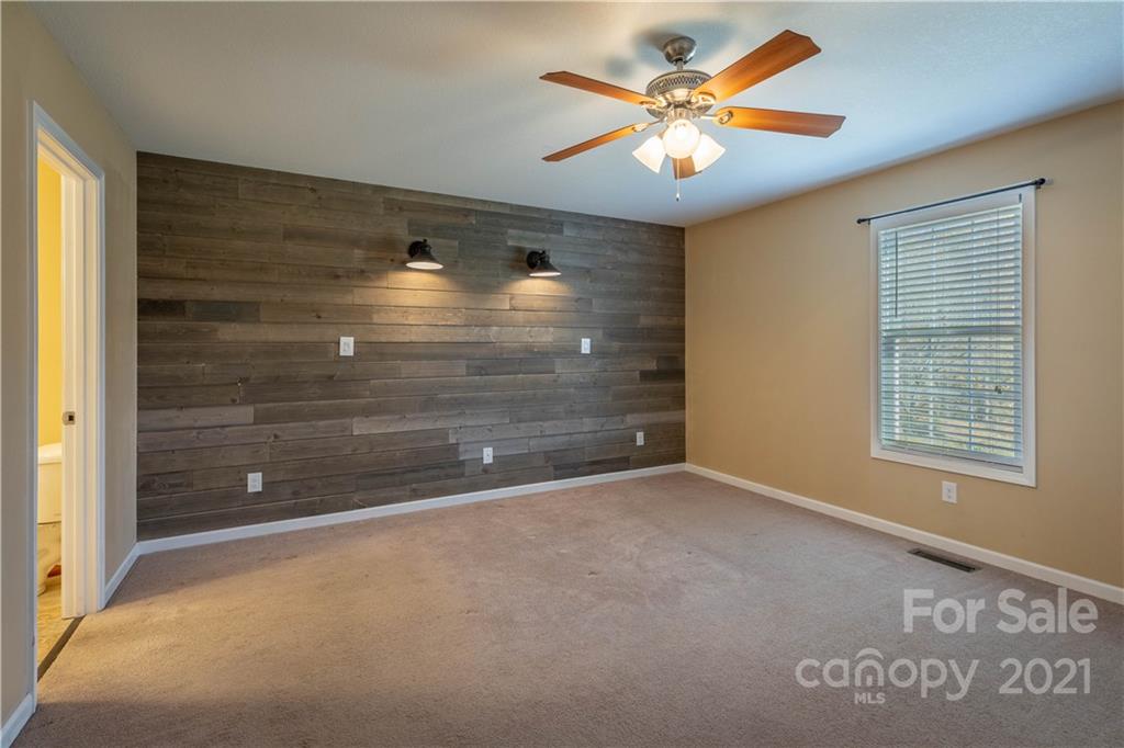 3604 Deerbrook Road Lenoir, NC 28645 - Photo 11 of 21 a view of an empty room with a ceiling fan and window
