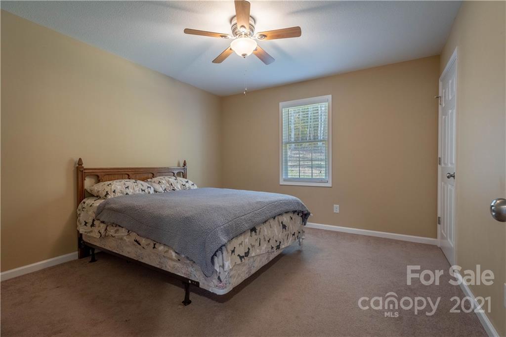 3604 Deerbrook Road Lenoir, NC 28645 - Photo 14 of 21 a bed sitting in a bedroom next to a window