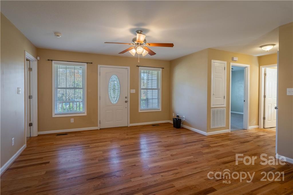 3604 Deerbrook Road Lenoir, NC 28645 - Photo 4 of 21 a view of an empty room with window and wooden floor