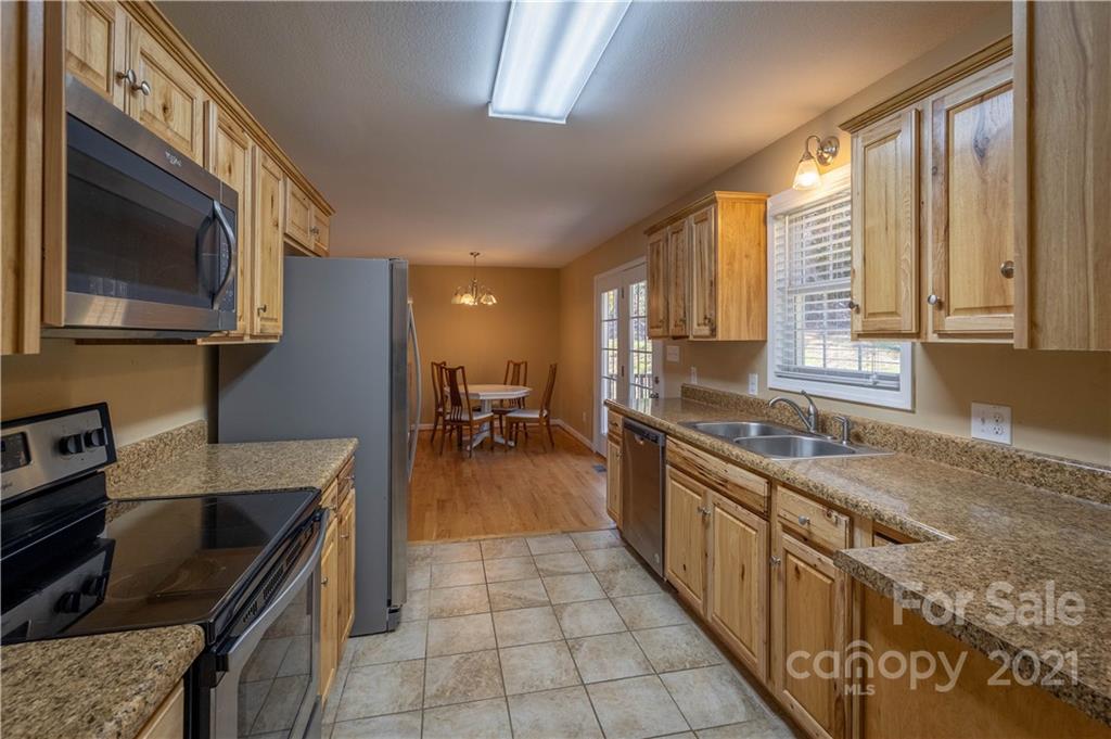 3604 Deerbrook Road Lenoir, NC 28645 - Photo 7 of 21 a kitchen with a stove a sink and a microwave