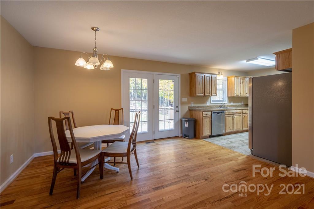 3604 Deerbrook Road Lenoir, NC 28645 - Photo 9 of 21 a view of a dining room with furniture a chandelier and wooden floor