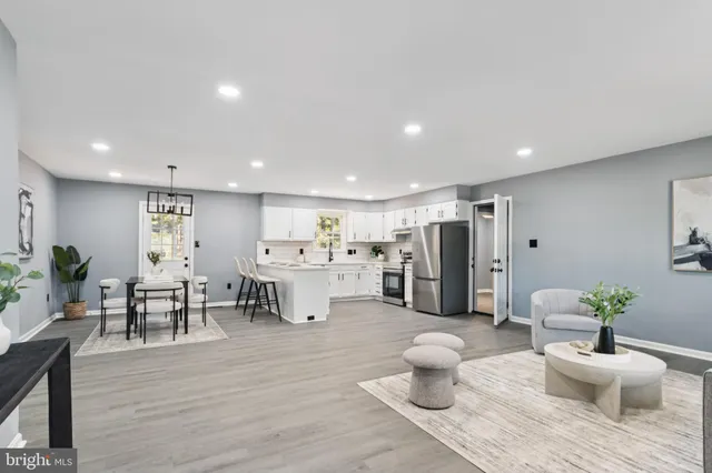 a living room with furniture and a dining table with wooden floor
