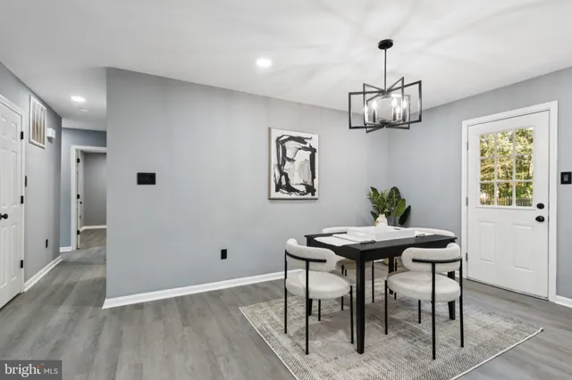 a view of a dining room with furniture wooden floor and a chandelier