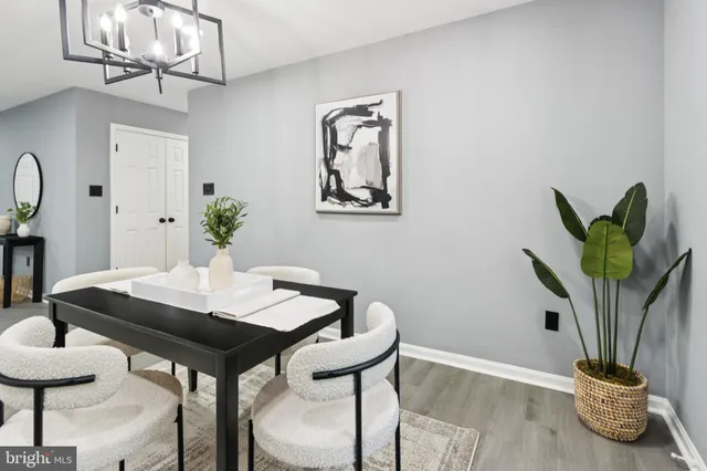 a view of a dining room with furniture and potted plant