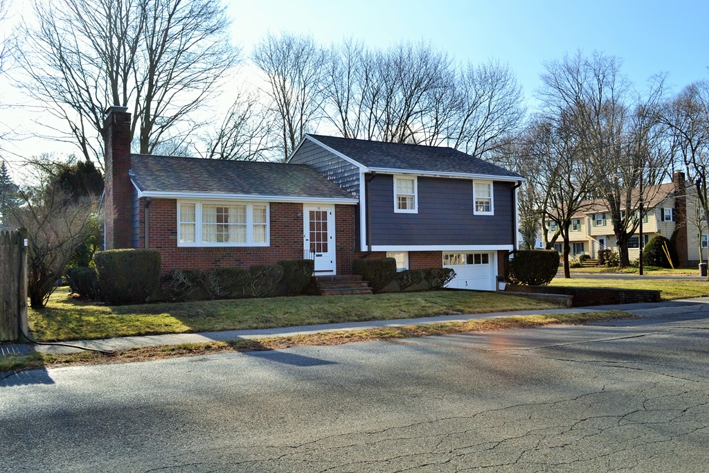 a view of street with a house in the background